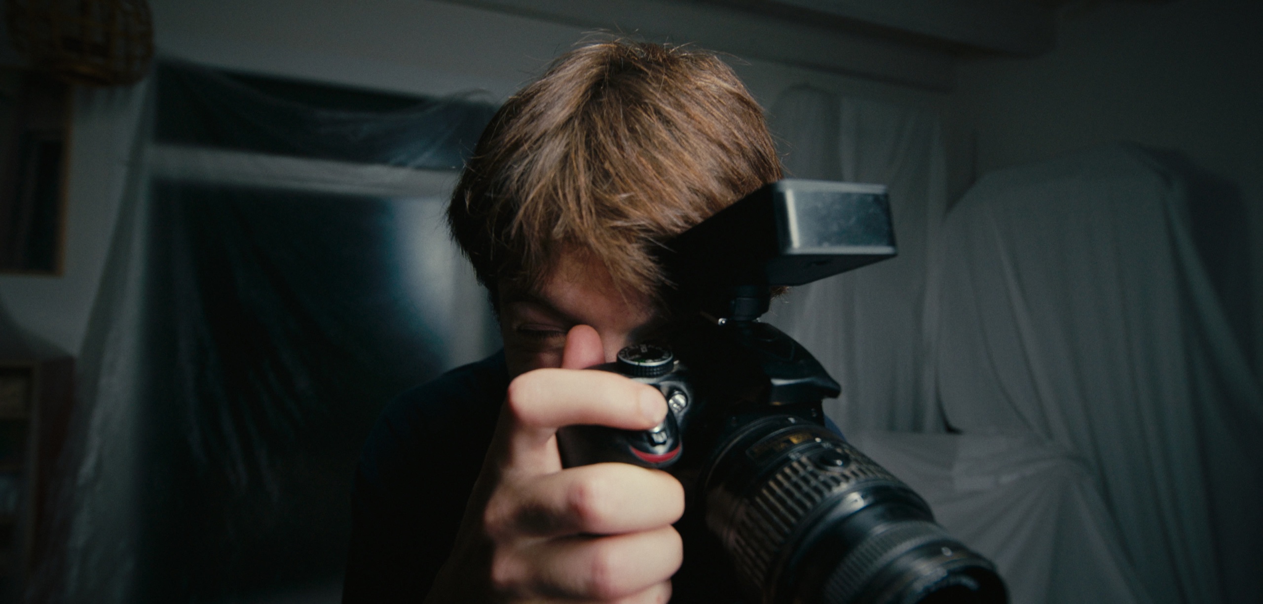 10 (Dieci): Mattia (Elia Nuzzolo) porta una macchina fotografica all'occhio