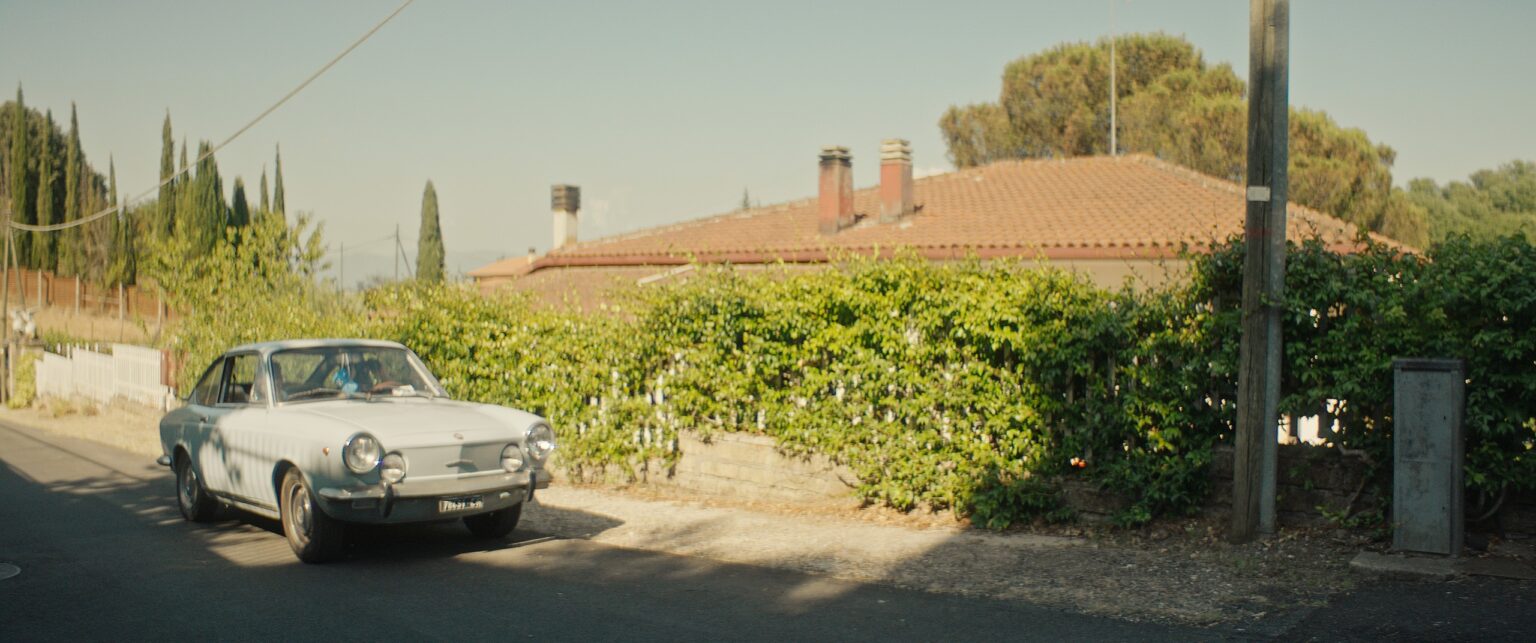 La Truffa, directed by Matteo Stipa and Michele Marchionne: a white vintage car on a country road